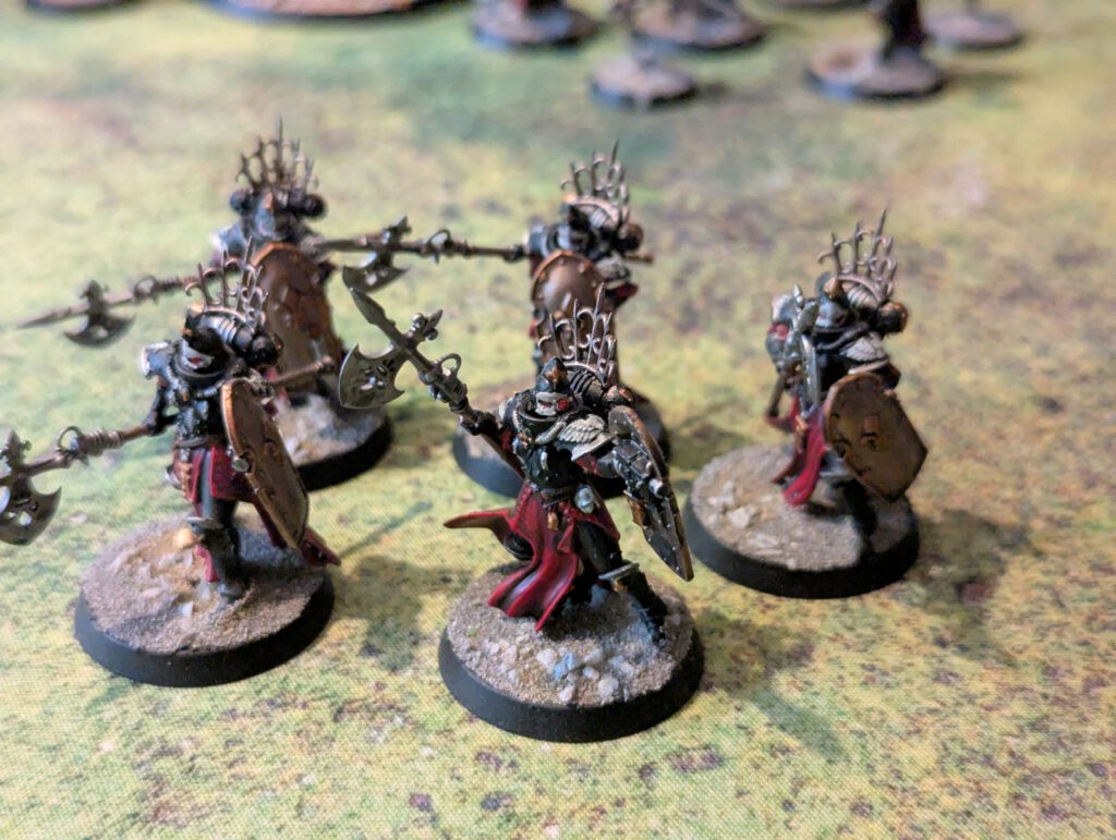 Five painted Celestian Sacresants with halberds and shields, viewed from top-front angle.