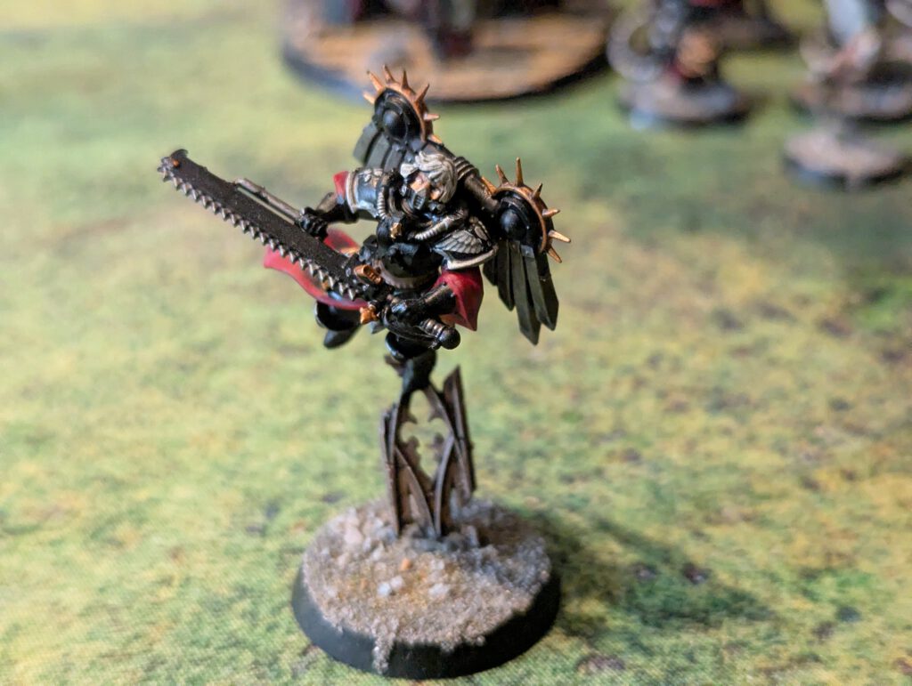 Painted Canoness with jump pack mid-flight, viewed from top-front angle against neutral background.