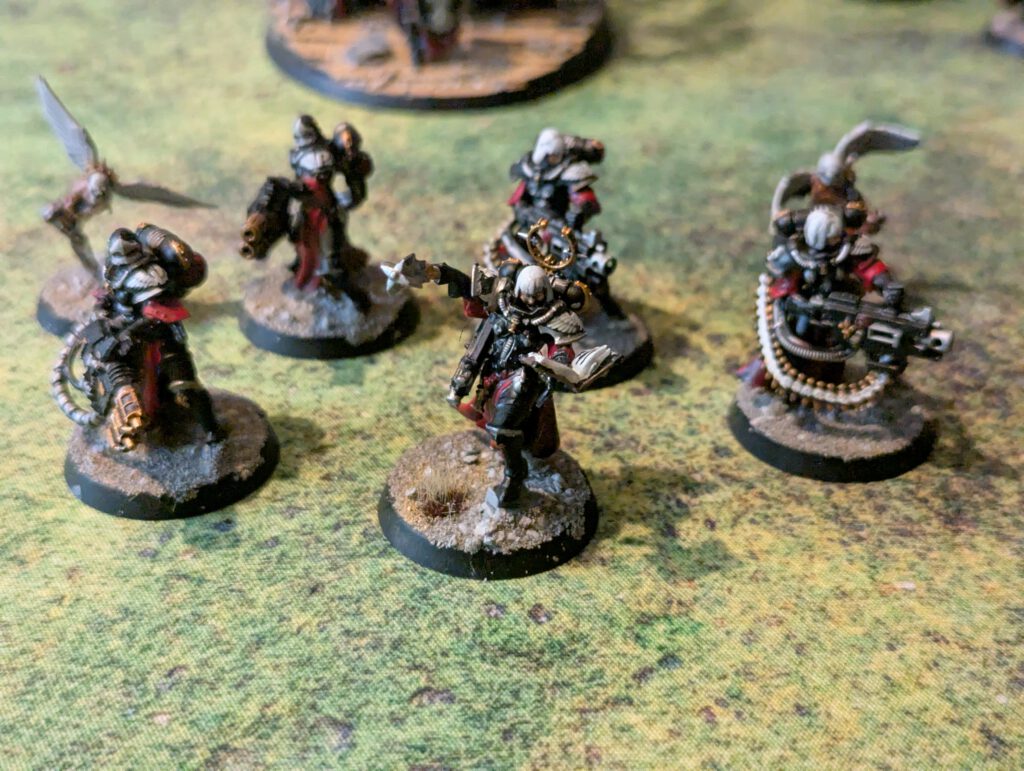 Five painted Retributors with heavy weapons from Adepta Sororitas, front-facing top view highlighting armor highlights.