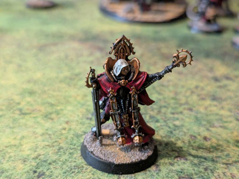Painted Canoness with power sword and relic pistol, top-front angle on textured base.