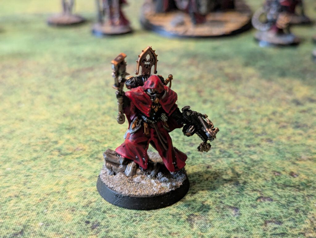 Painted Canoness model with mace and Crossbow, front-facing top view showing robes and armor detail.