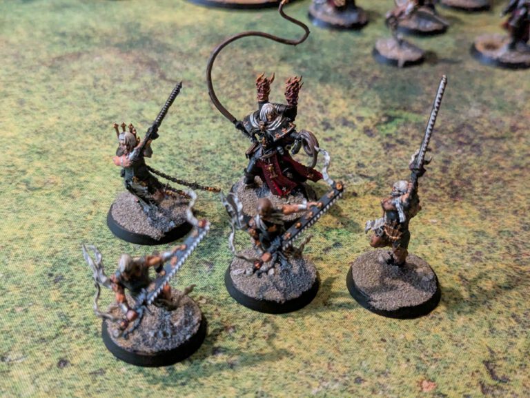 Five painted Repentia models, viewed from top-front angle showing dynamic poses.