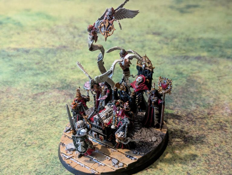 Painted Triumph of Saint Katherine centerpiece with attendants from Adepta Sororitas army, top-front view showing full display base.