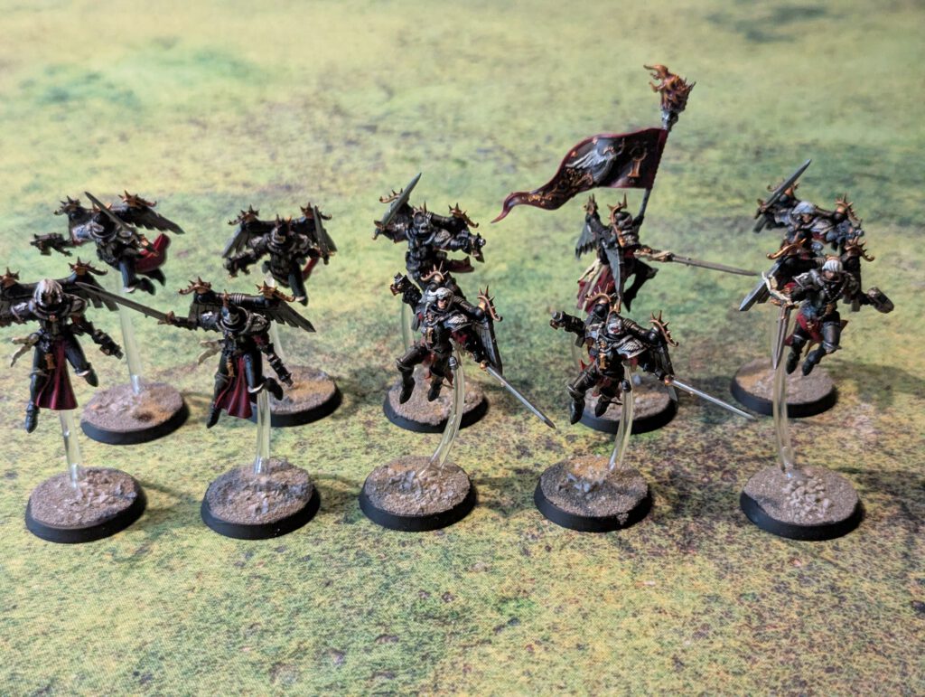 Ten painted Zephyrim wielding power swords, top-front view emphasizing wings and motion.