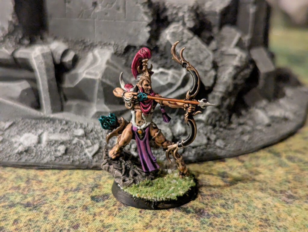 Painted Blissbarb Archer with bow drawn, viewed from a front angle.