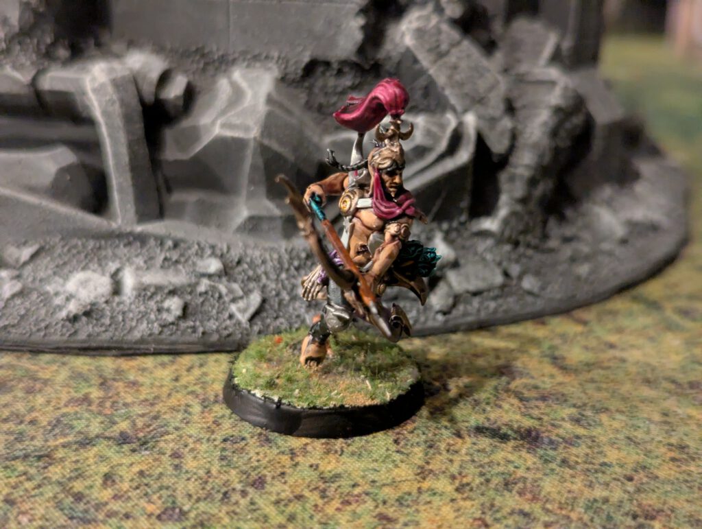 Painted Blissbarb Archer stepping forward with bow ready, front angle.