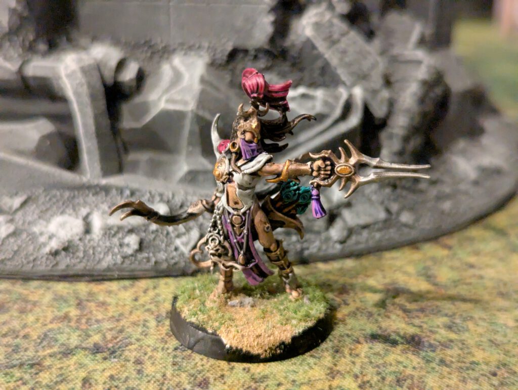 Painted Blissbarb Archer pointing forwards viewed from a slightly elevated front angle.