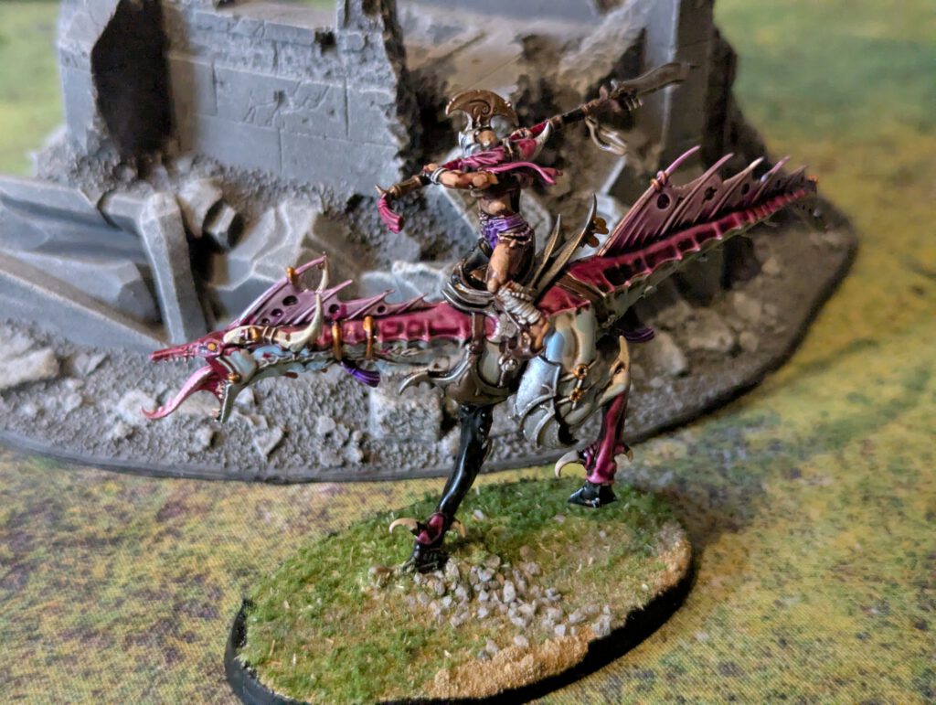 Painted Slickblade Seeker on mount with glaive raised, front angle.