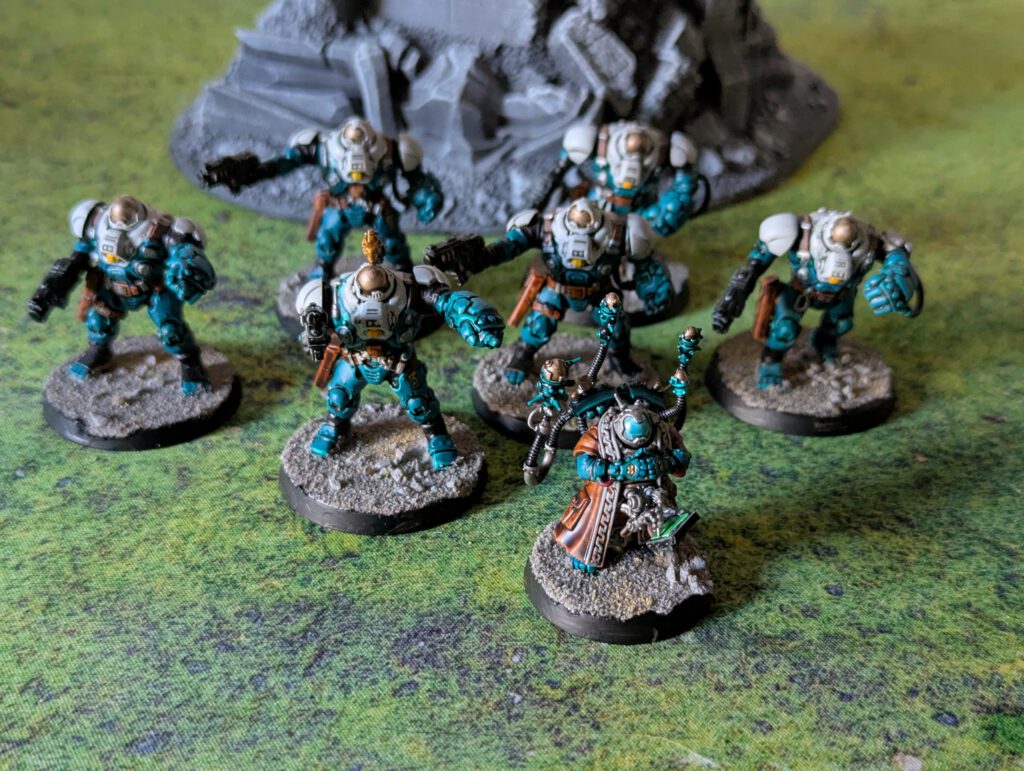 Painted Ironkin Steeljacks with gauntlets and a Memnyr Strategist displayed together in a group shot, viewed from a top-front angle.