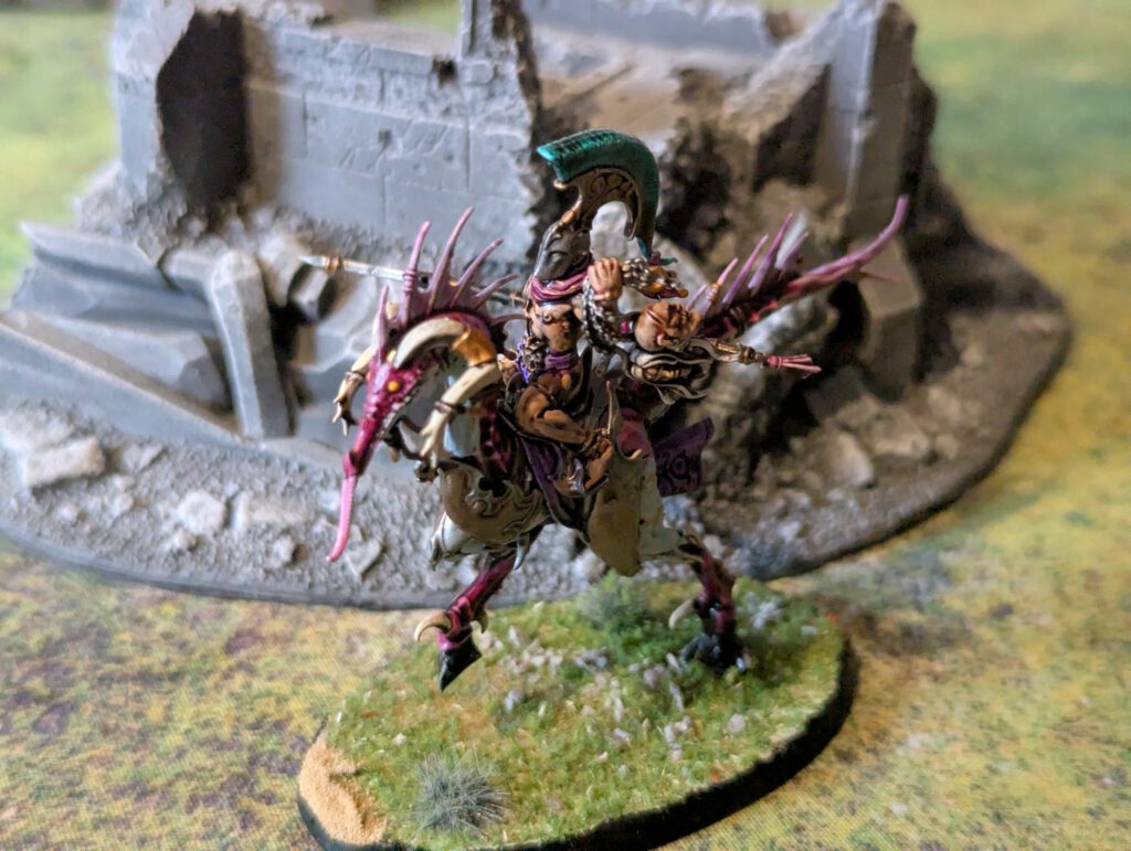 Painted Slickblade Seeker with ornate Slaanesh armor, viewed from a slightly elevated front angle.