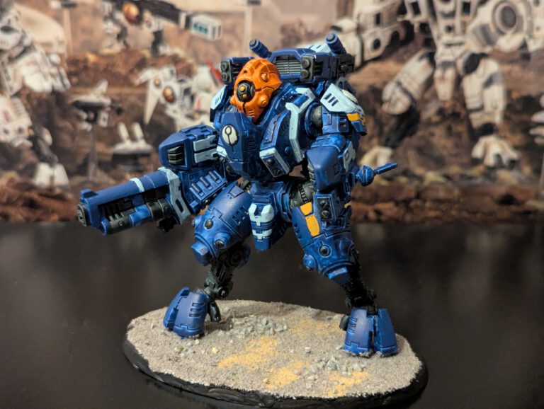 Painted T’au Ghostkeel Battlesuit with stealth drone details, viewed from a top-front angle.