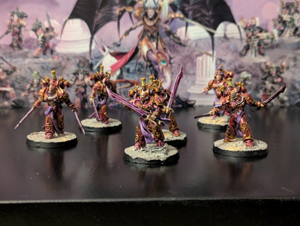 Painted Flawless Blades unit of six Emperor’s Children warriors, displayed together from a slightly elevated front view.