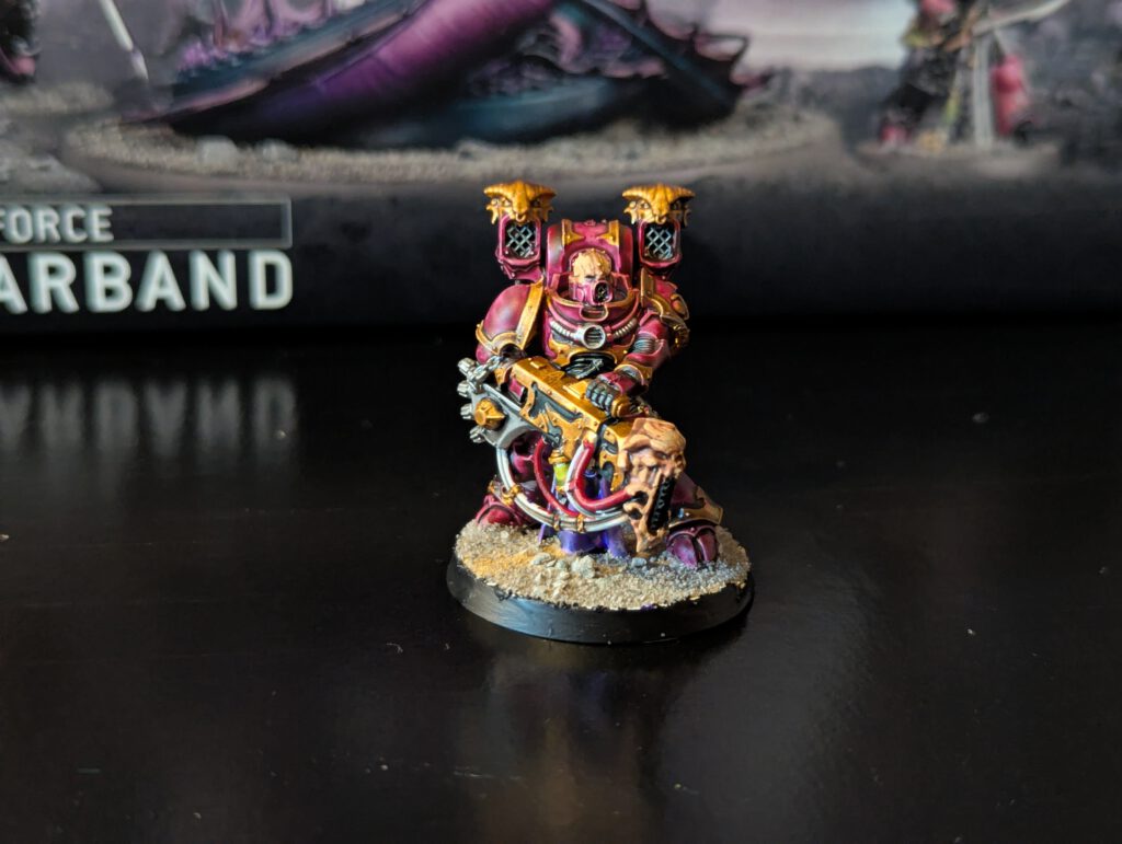 Painted Noise Marine firing sonic blaster, viewed from a slightly elevated front angle.