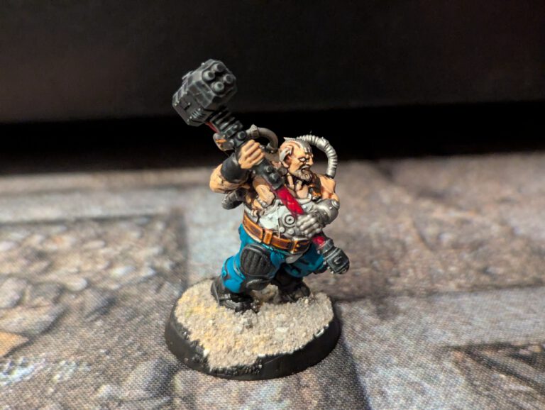 Painted Cthonian Berserk wielding a heavy hammer, viewed from a front angle.