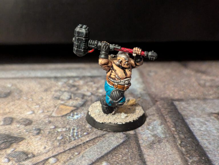 Painted Cthonian Berserk in an aggressive stance with hammer, viewed from a top-front angle.