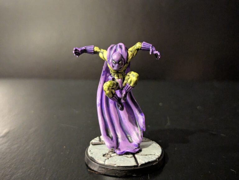 Painted Prowler miniature from Marvel Crisis Protocol, shown from a top-front angle with cloak and tech details visible.