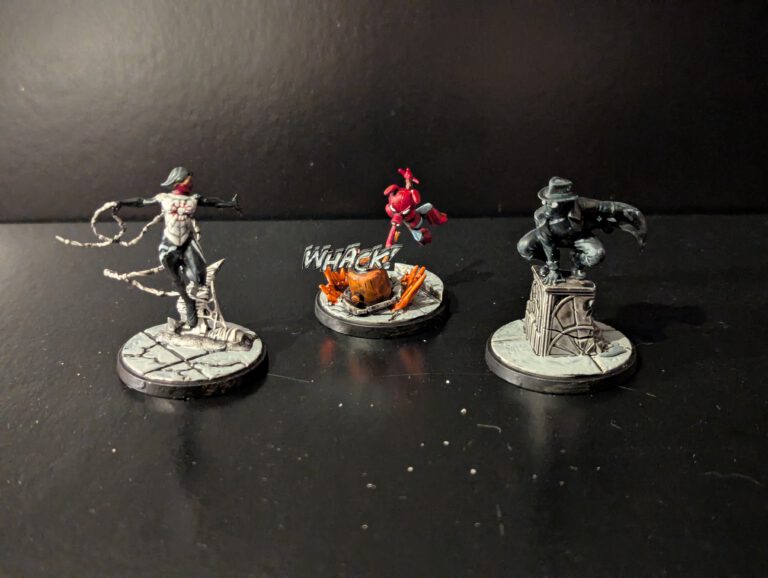 Painted Marvel Crisis Protocol miniatures of Silk, Spider-Ham, and Spider-Man Noir displayed together from a top-front angle.