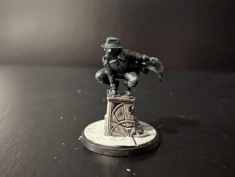 Painted Spider-Man Noir miniature from Marvel Crisis Protocol, viewed from a top-front angle highlighting the trench coat and noir styling.