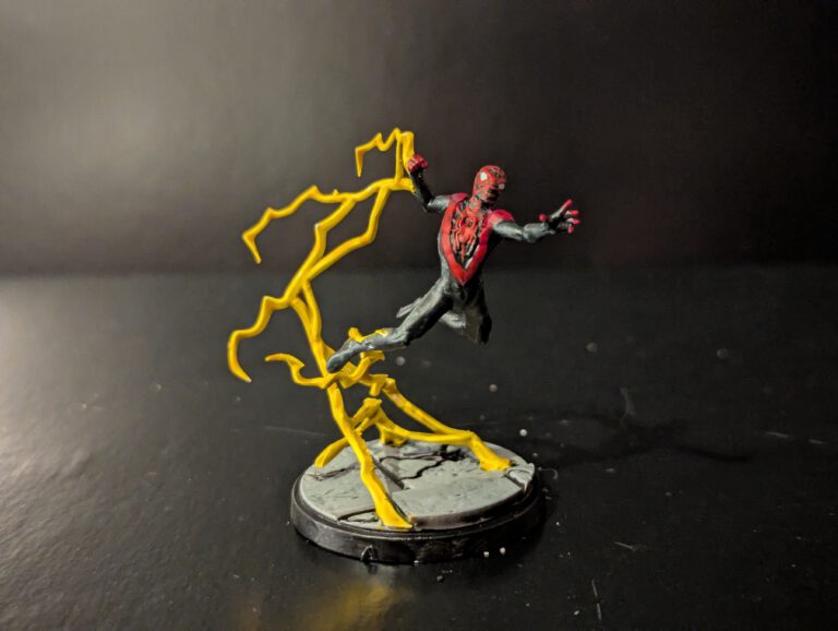 Painted Ultimate Spider-Man miniature from Marvel Crisis Protocol, shown from a top-front angle with dynamic pose and suit details.