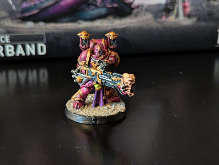 Painted Noise Marine holding sonic weapon low, viewed from a top-front angle.