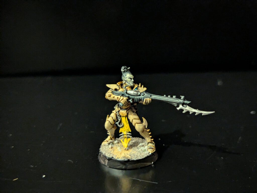 Painted Kabalite Warrior with dynamic stance and armored details, viewed from a front angle.