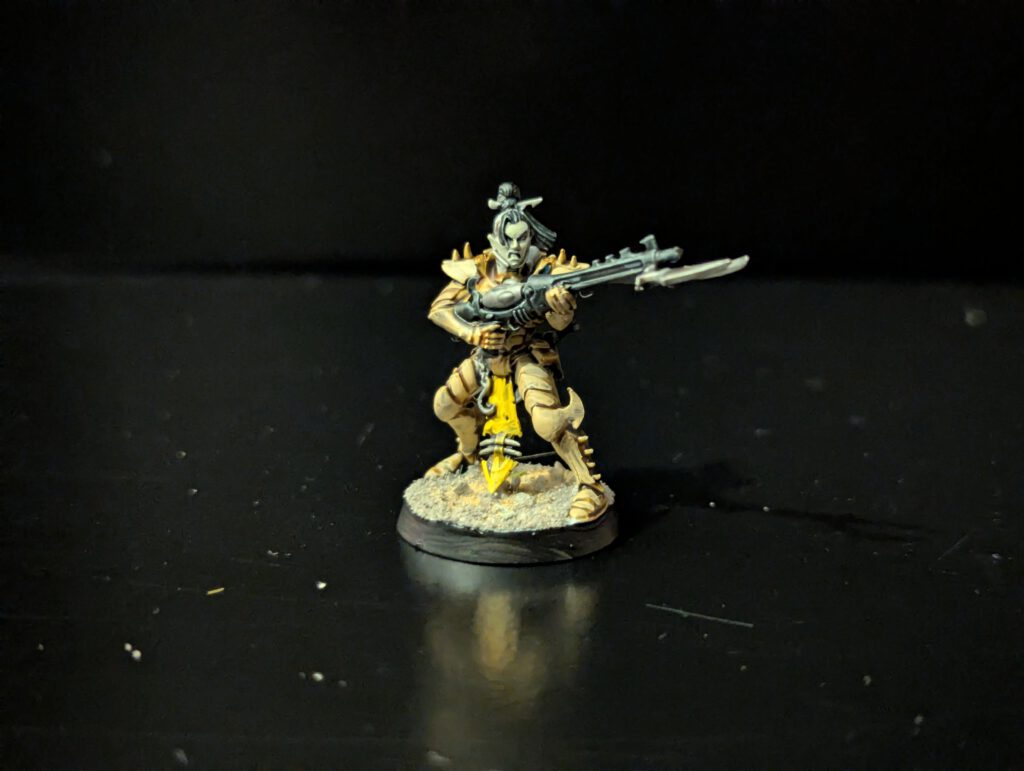 Painted Kabalite Warrior mid-stride with splinter rifle, viewed from a top-front angle.