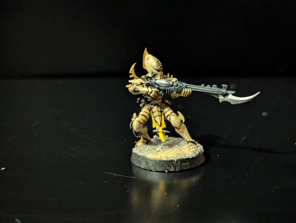 Painted Kabalite Warrior with aggressive pose and weapon ready, viewed from a front angle.