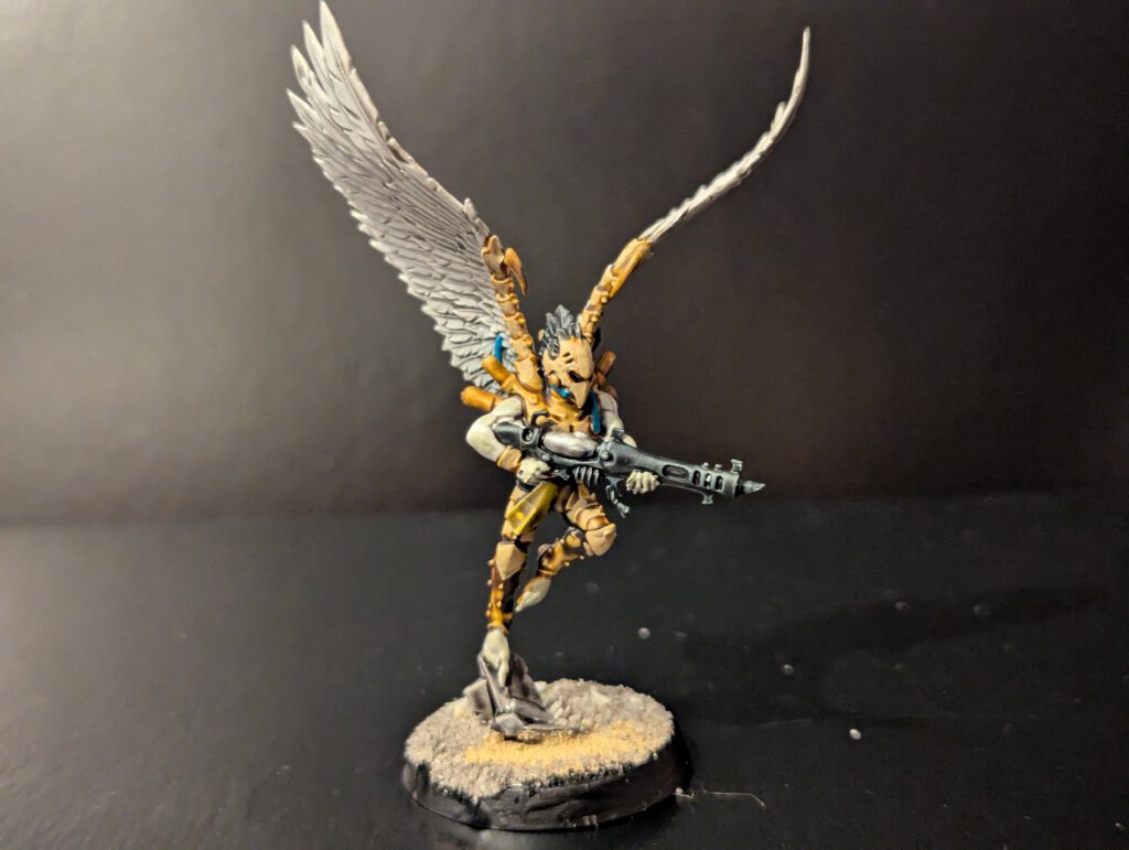 Painted Scourge in mid-flight pose, viewed from a slightly elevated front angle.