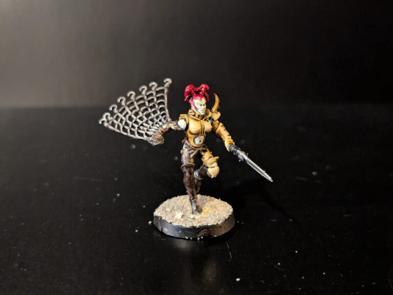 Painted Wych in acrobatic combat pose, viewed from a front angle.