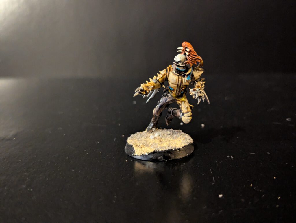 Painted Wych with flowing motion and combat blades, viewed from a front angle.