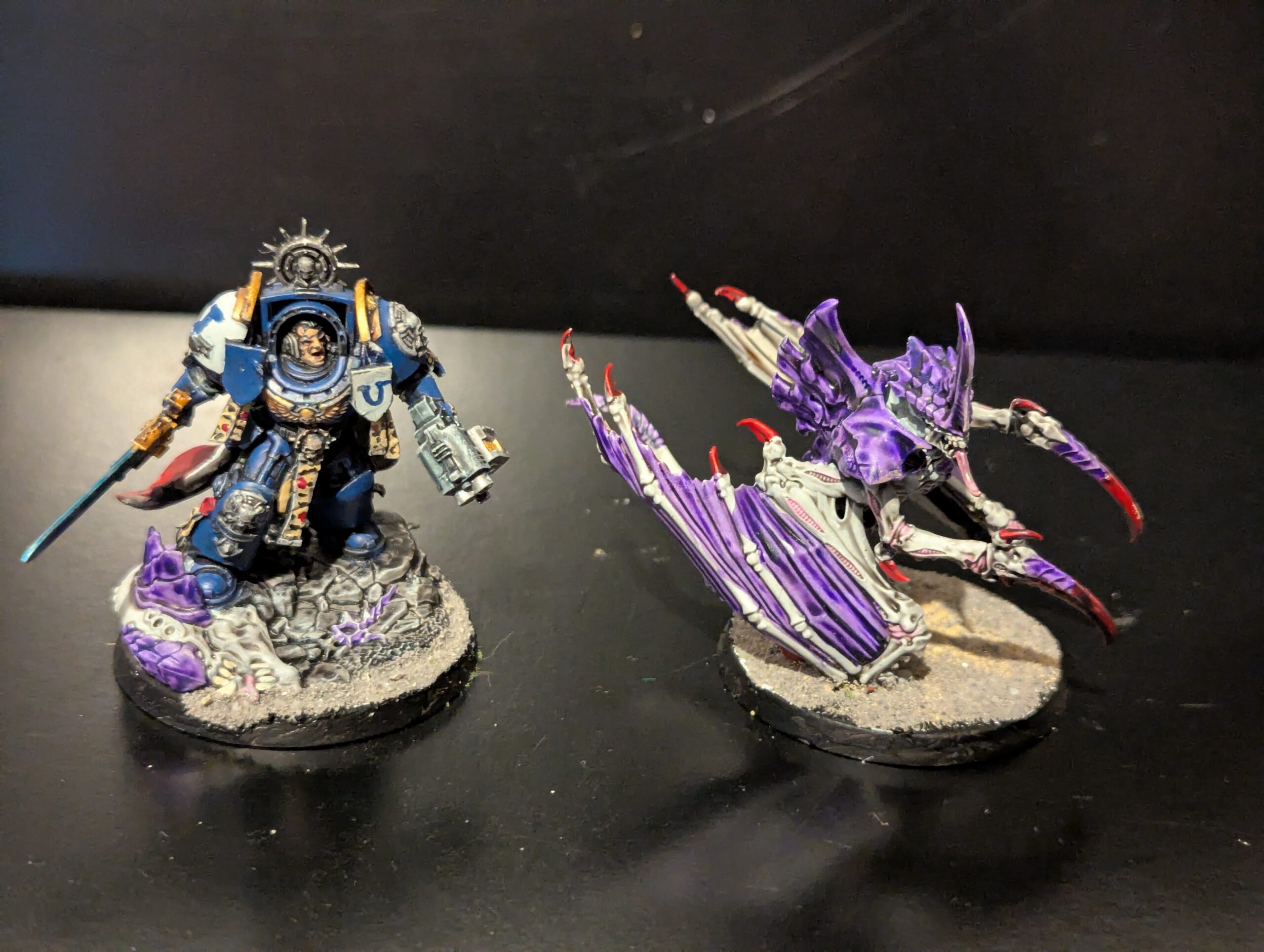 Winged Tyranid Prime and Space Marine Captain in Terminator Armor miniatures from Combat Patrol Magazine 1, shown together, highlighting scale and paint contrast.