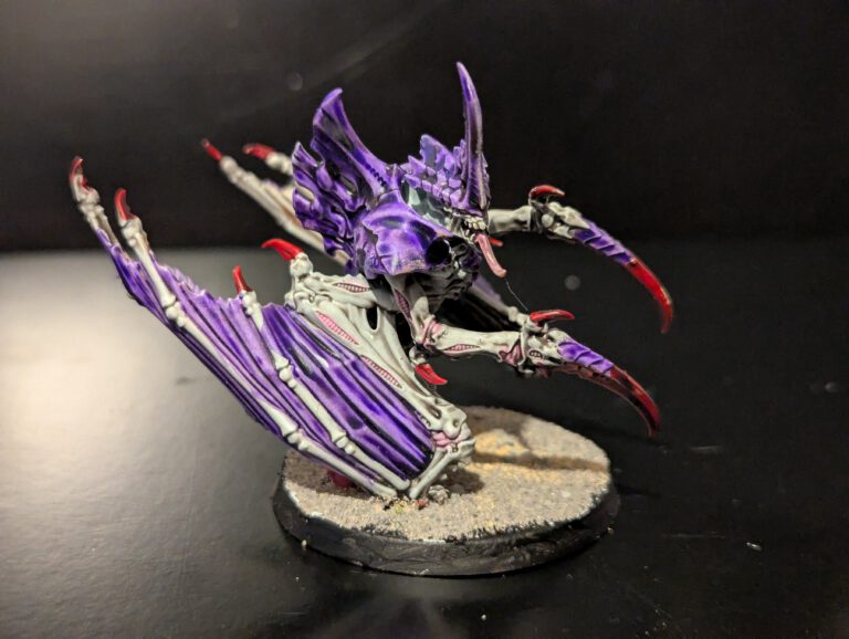 Winged Tyranid Prime miniature from Combat Patrol Magazine 1, painted in purple and bone tones, with wings and sharp claws, displayed on a textured base.
