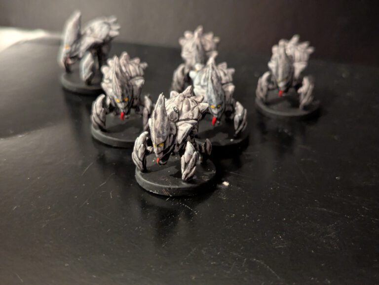 Six Cave Sickle miniatures painted in a chitinous, insectoid scheme with sharp claw details.