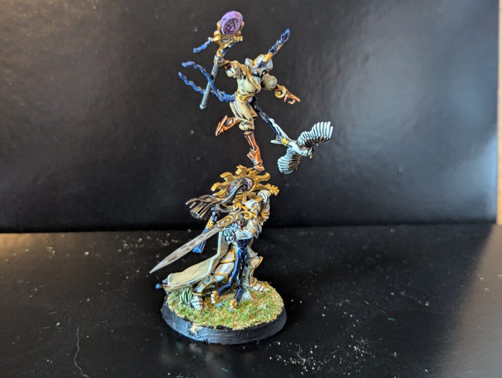 Painted Ellania and Ellathor, Eclipsian Warsages, showing the magical energy effects and flowing blue and white robes.