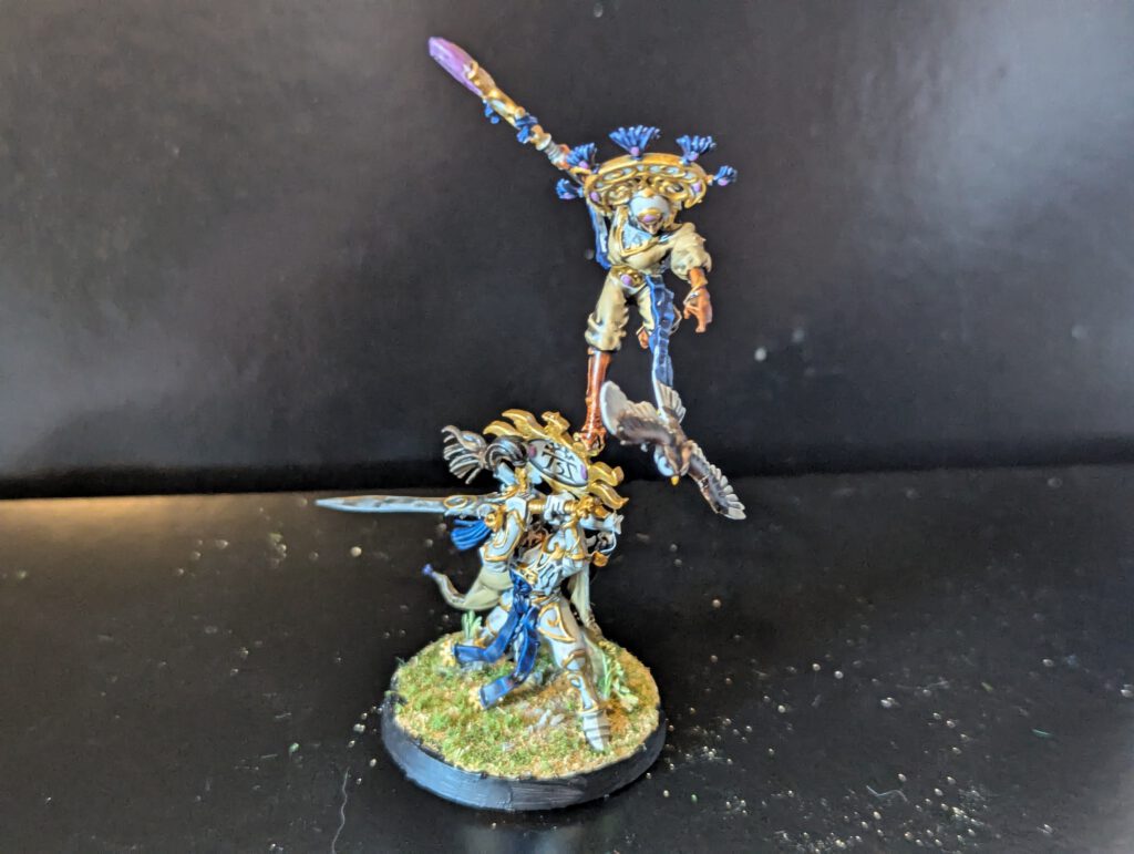 Alternate front angle of the Eclipsian Warsages miniature highlighting the twin characters and their ornate staves.