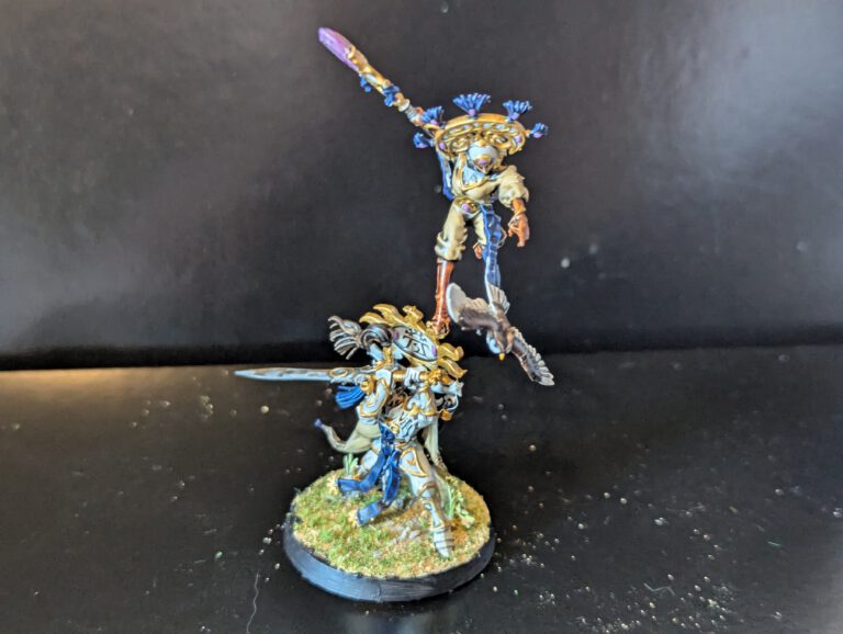 Alternate front angle of the Eclipsian Warsages miniature highlighting the twin characters and their ornate staves.