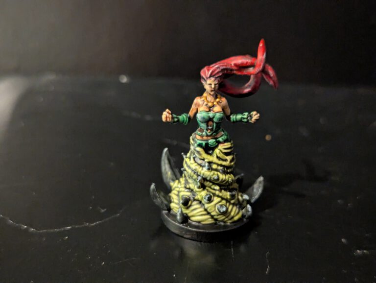 A single Living Oblation figure painted with eerie, pale skin and dark, tattered clothing