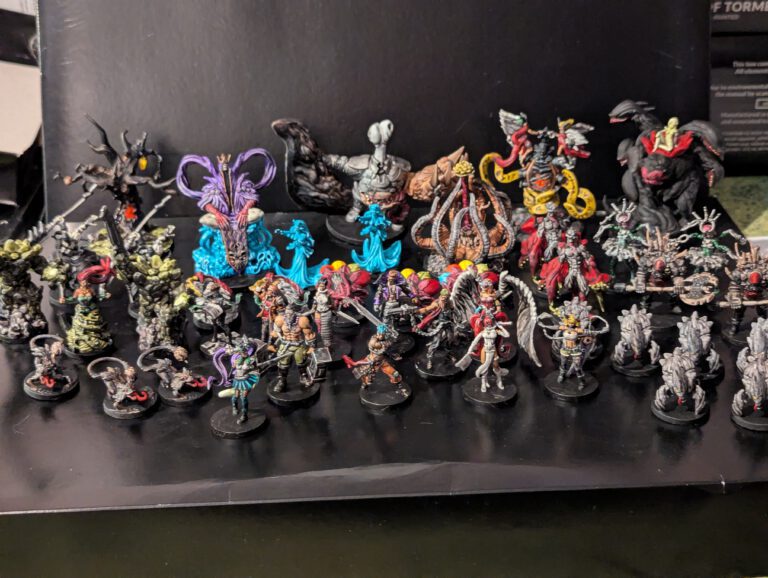 A wide group shot of all miniatures from the Middara Act 1 box, including heroes, monsters, and bosses, all fully painted.