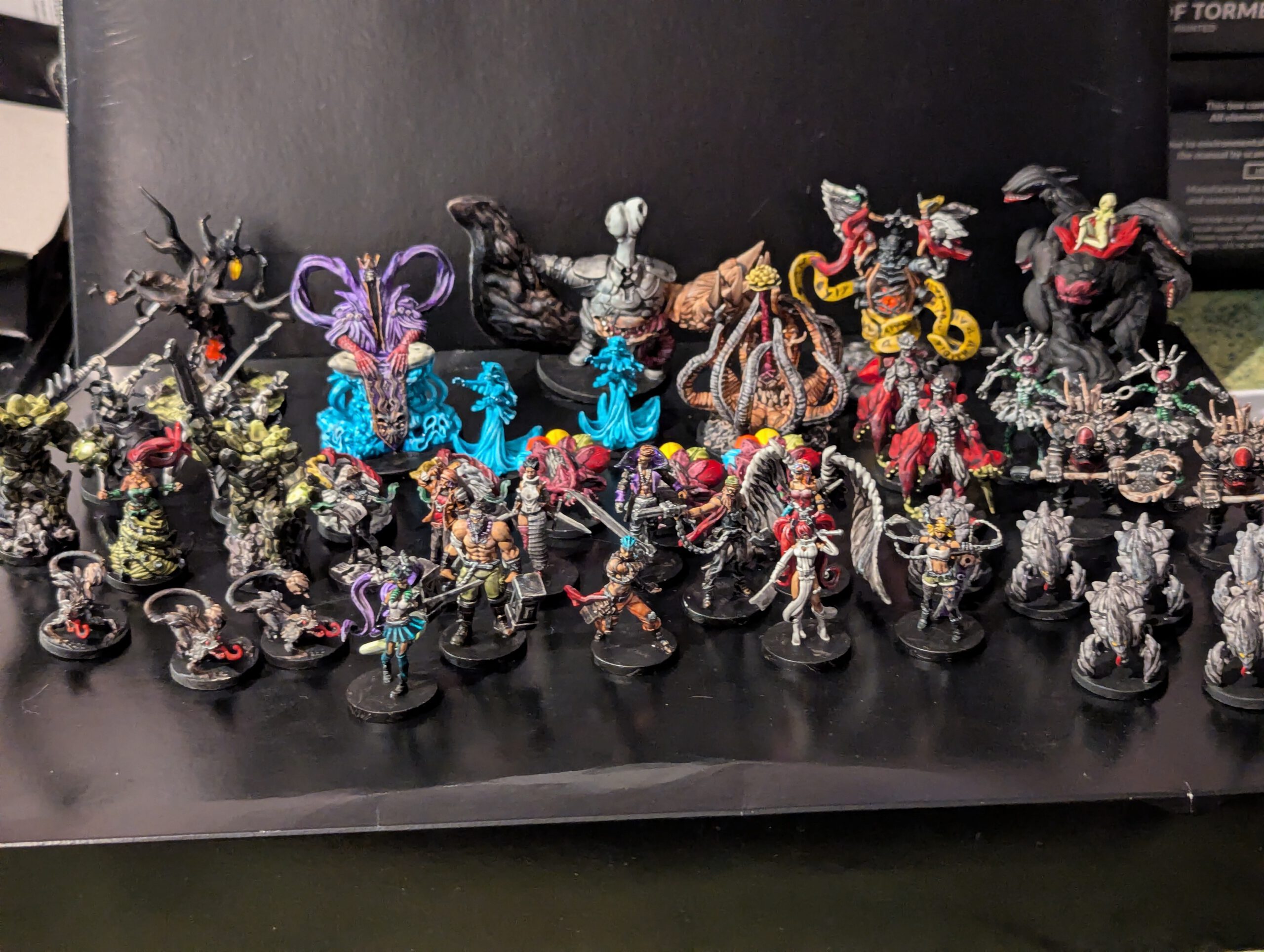 A wide group shot of all miniatures from the Middara Act 1 box, including heroes, monsters, and bosses, all fully painted.