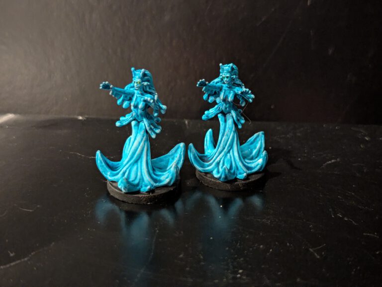 Two Water Loa miniatures painted with translucent blue effects and fluid highlights.