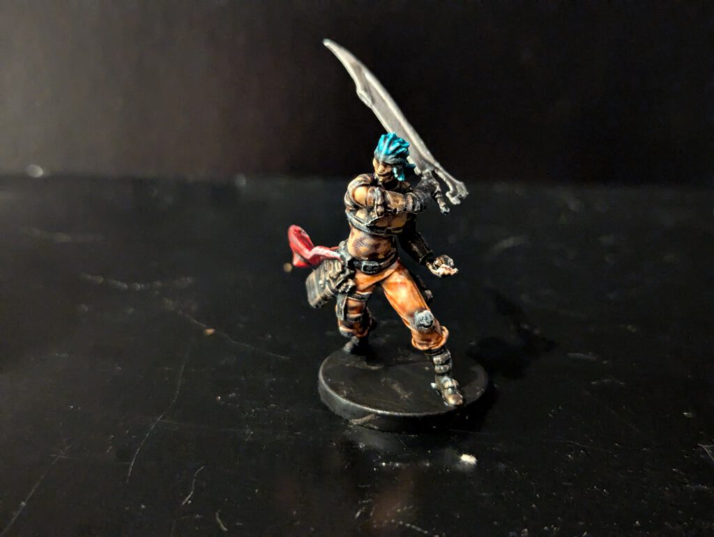 Painted Zafir miniature showcasing his detailed leather armor and dynamic sword-wielding pose.
