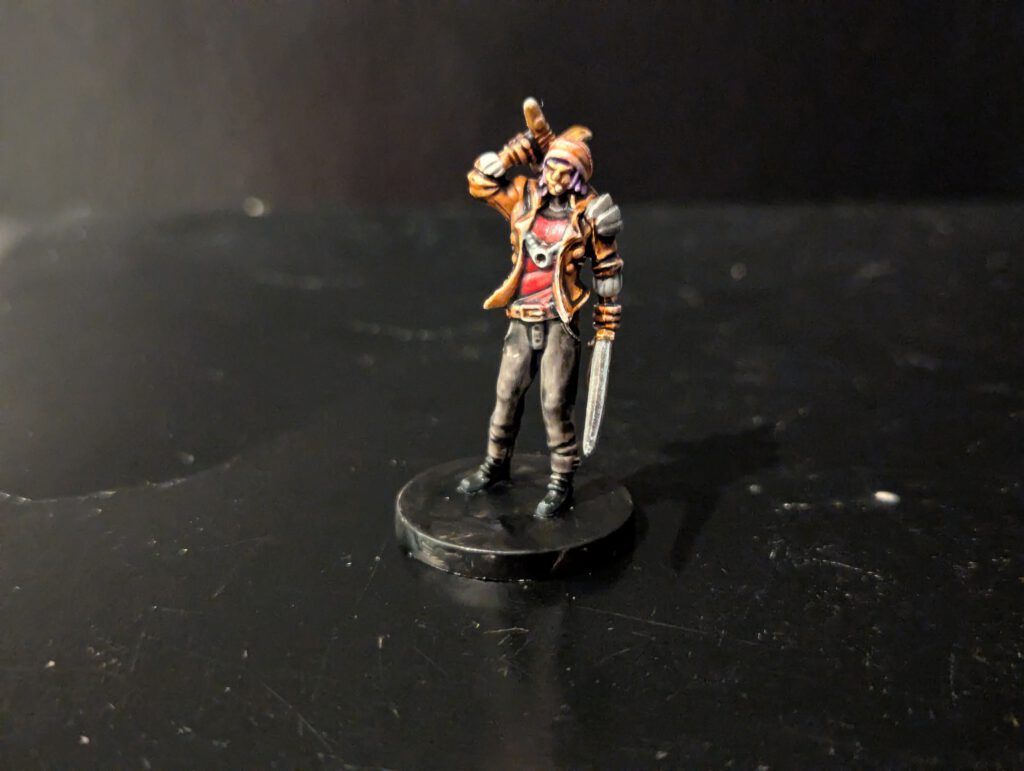 Painted Zeke Jeong miniature from Middara, featuring his signature coat and twin blades.