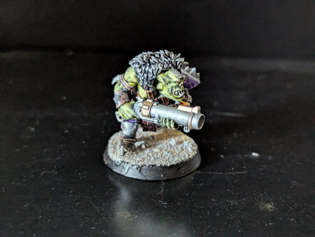 Individual painted Ork Beast Snagga Boy showing purple scheme and bone trophies.