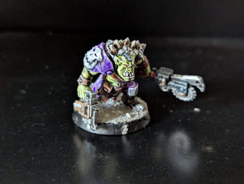 Individual painted Ork Beast Snagga Boy showing purple scheme and bone trophies.