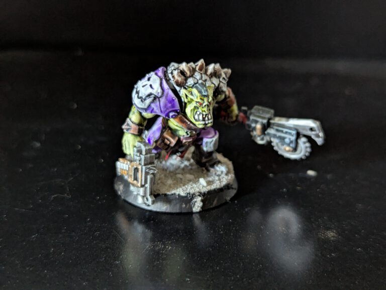Individual painted Ork Beast Snagga Boy showing purple scheme and bone trophies.