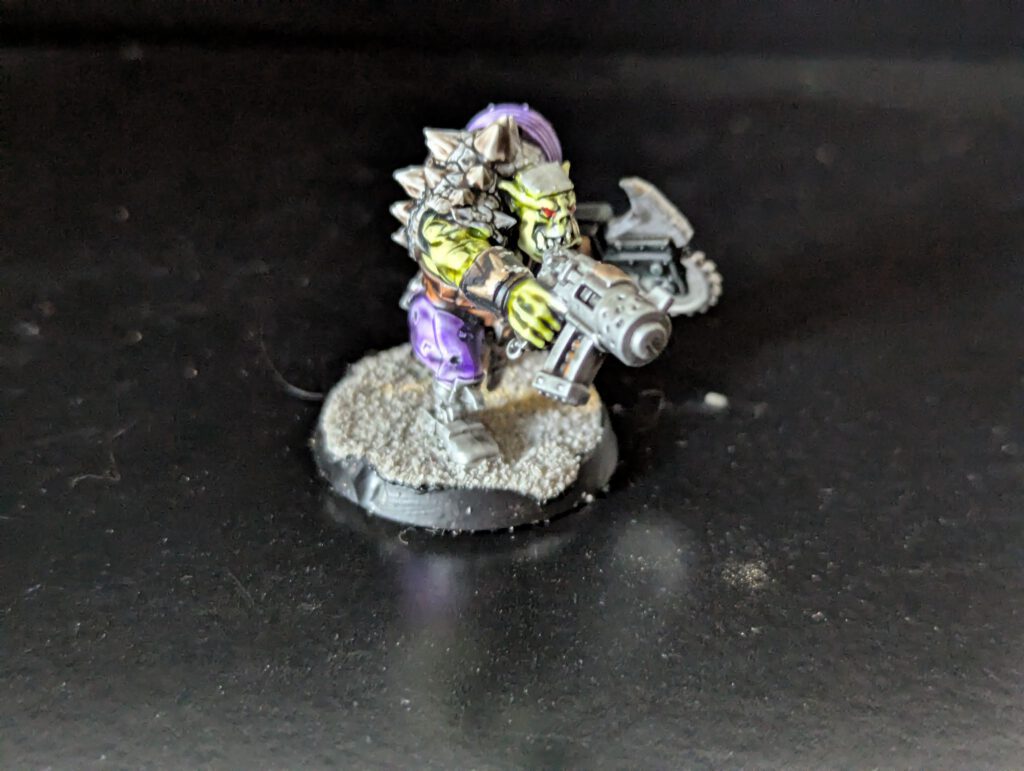 Individual painted Ork Beast Snagga Boy showing purple scheme and bone trophies.