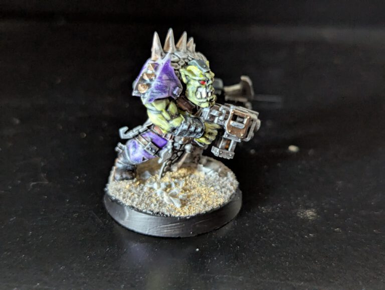 Individual painted Ork Beast Snagga Boy showing purple scheme and bone trophies.
