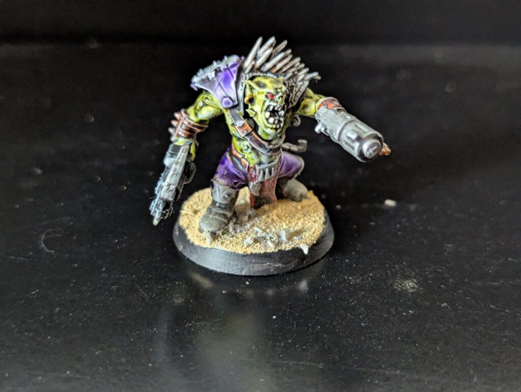 Individual painted Ork Beast Snagga Boy showing purple scheme and bone trophies.