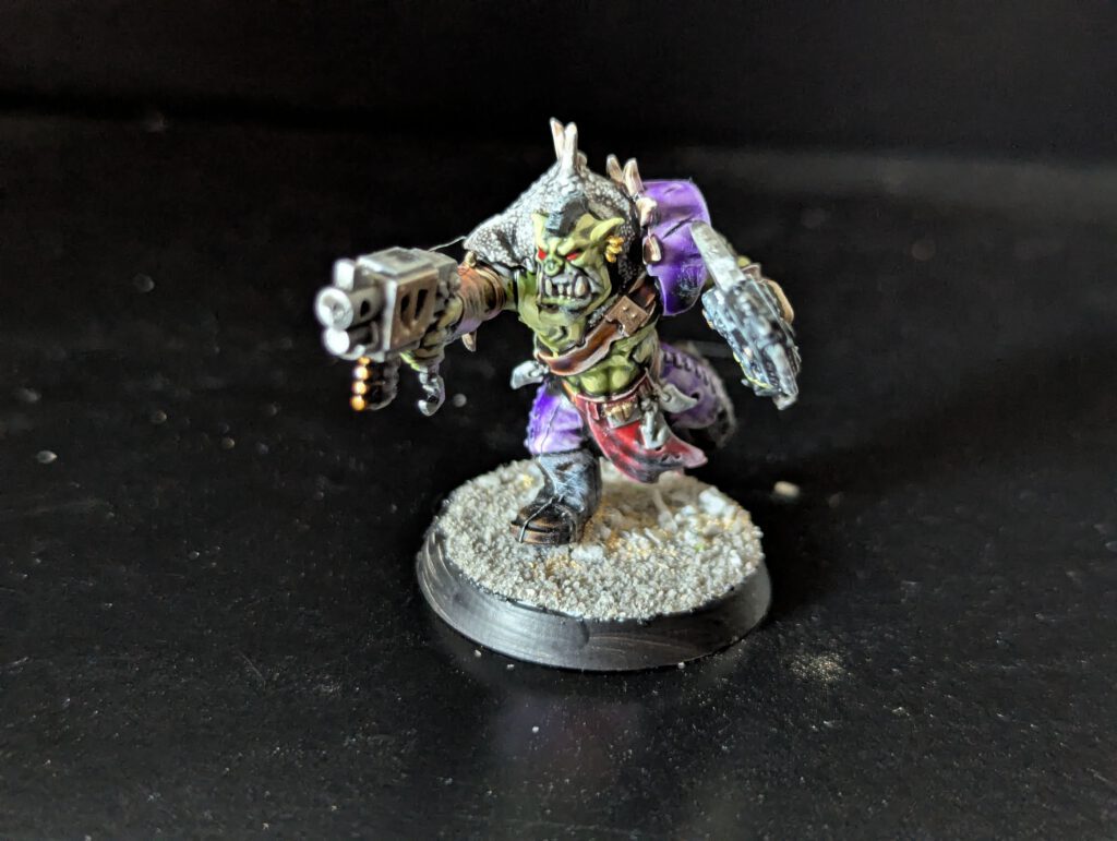 Individual painted Ork Beast Snagga Boy showing purple scheme and bone trophies.