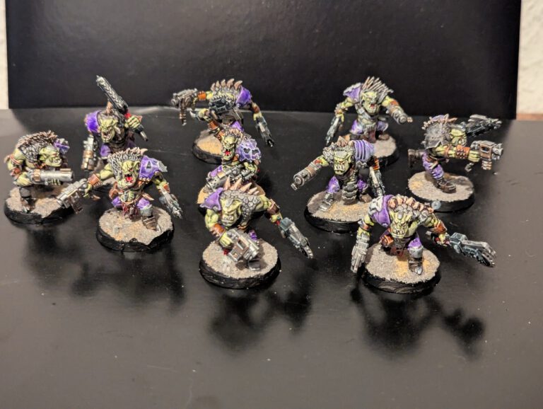 A squad of 10 painted Ork Beast Snagga Boyz ready for tabletop gaming.